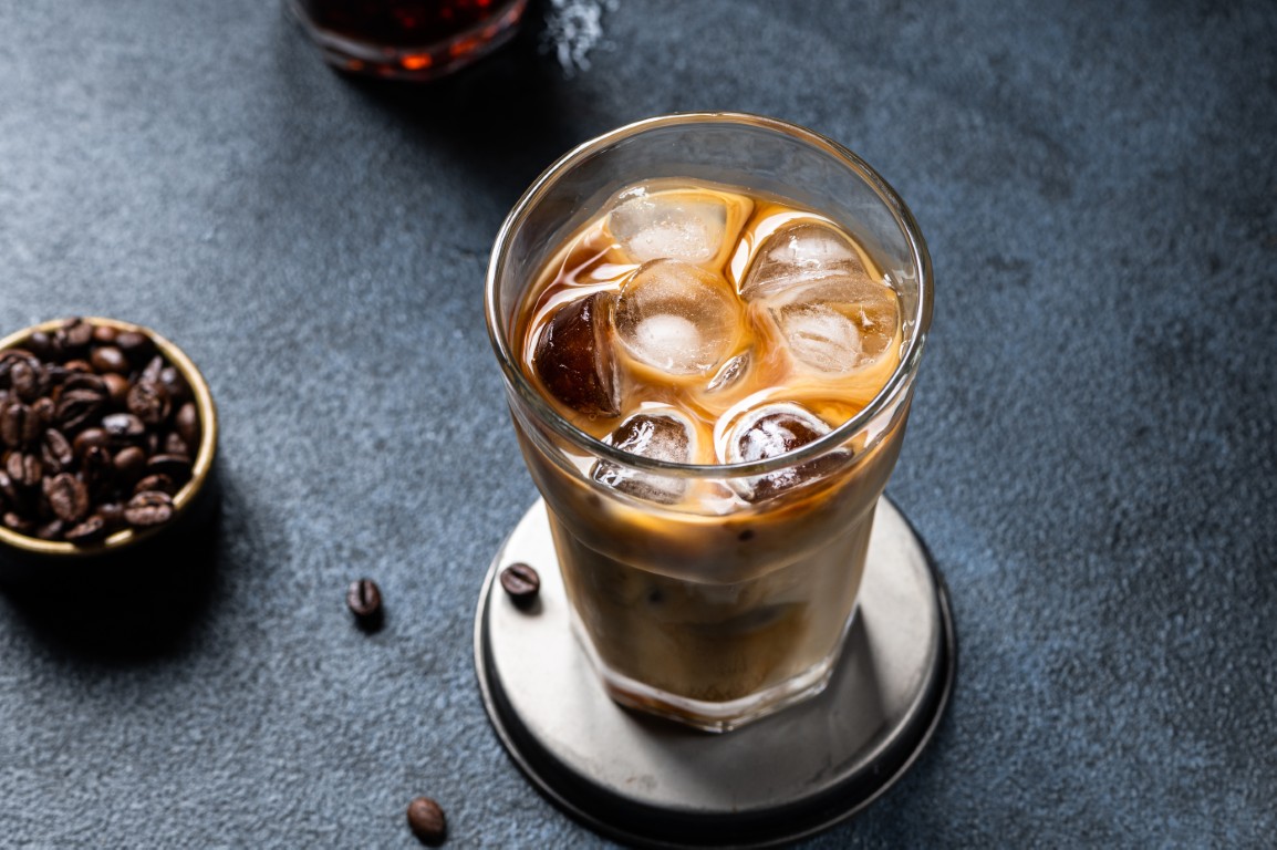 iced-coffee-in-a-tall-glass-with-cream-poured-over-2026-01-06-10-25-36-utc